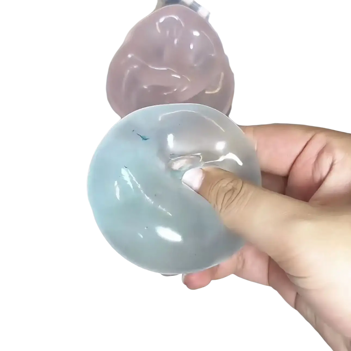 A translucent light blue gelatinous blue coconut oil stress ball squeeze toy held in hand with a pink one nearby
