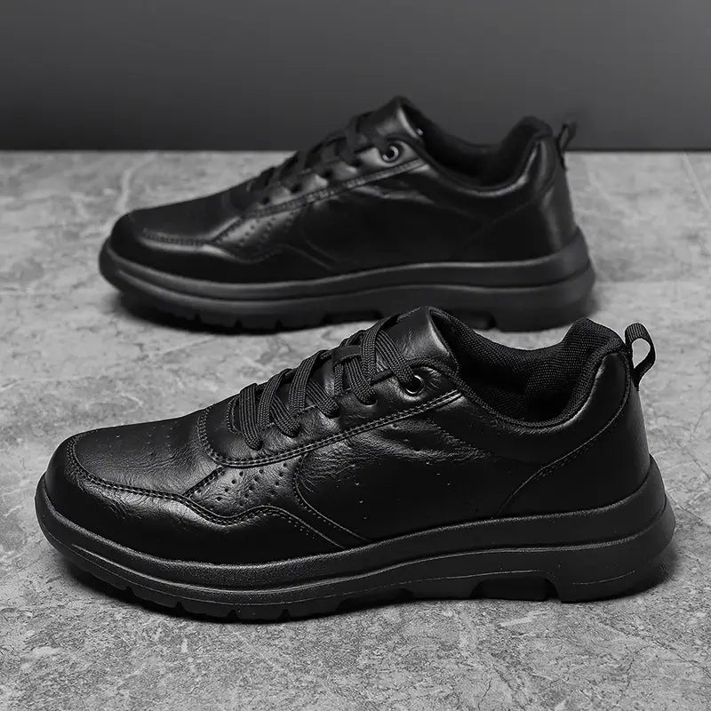 Men black leather chunky sole sneakers featuring perforated detailing and a durable thick sole for enhanced comfort and style.