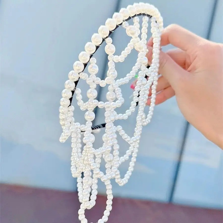 A delicate white pearl bridal crown hair band featuring multiple strands of lustrous pearls in a cascading tassel design.
