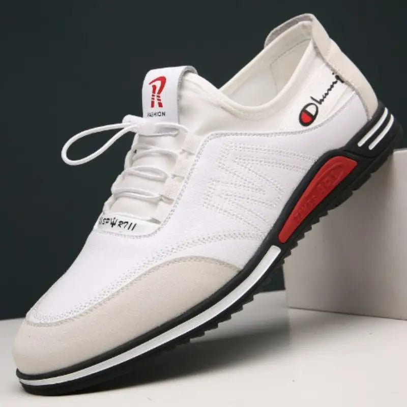 White leather men casual sneaker with red and black accents featuring a champion logo designed as a lightweight non slip shoe.