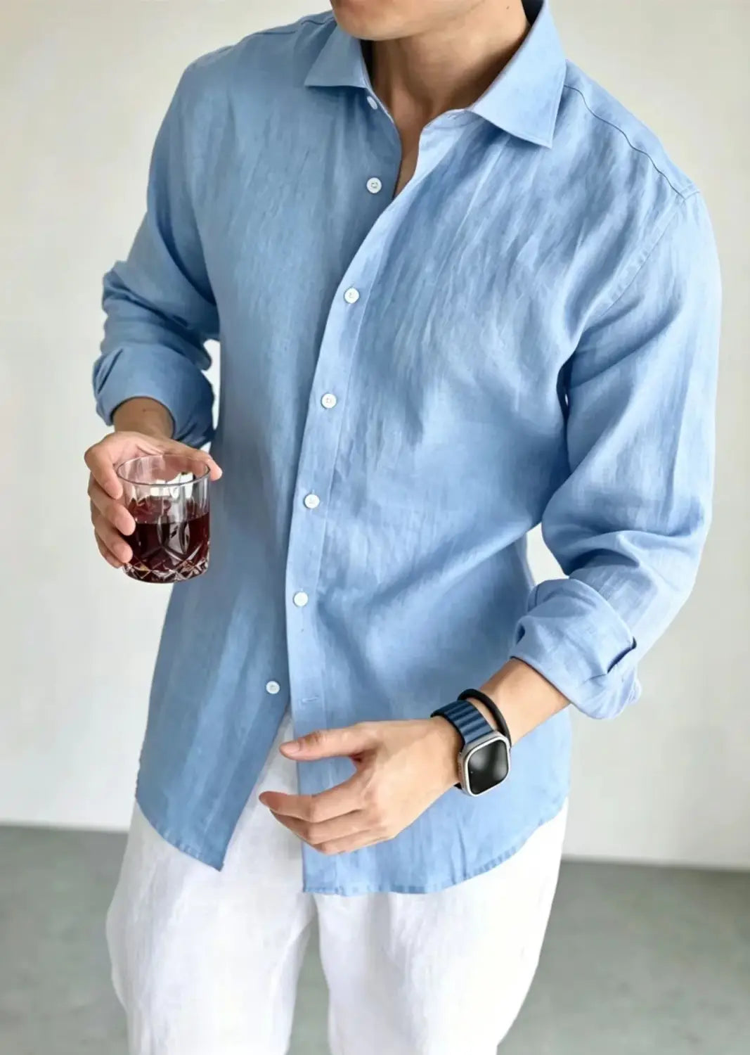 Light blue men cotton linen casual button down shirt with rolled-up sleeves and white buttons.
