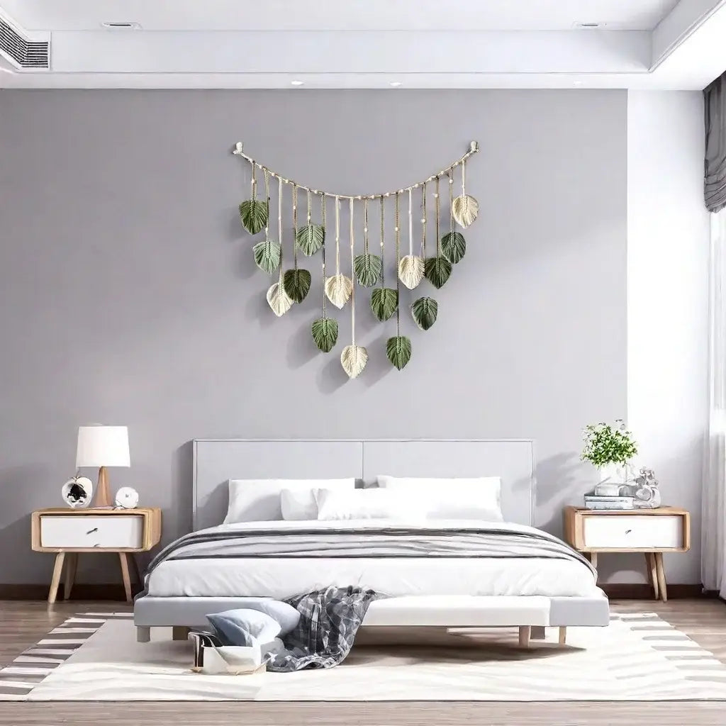 Macrame leaf wall hanging boho decor featuring a curved metal frame with dangling leaves in varying shades of green and cream.