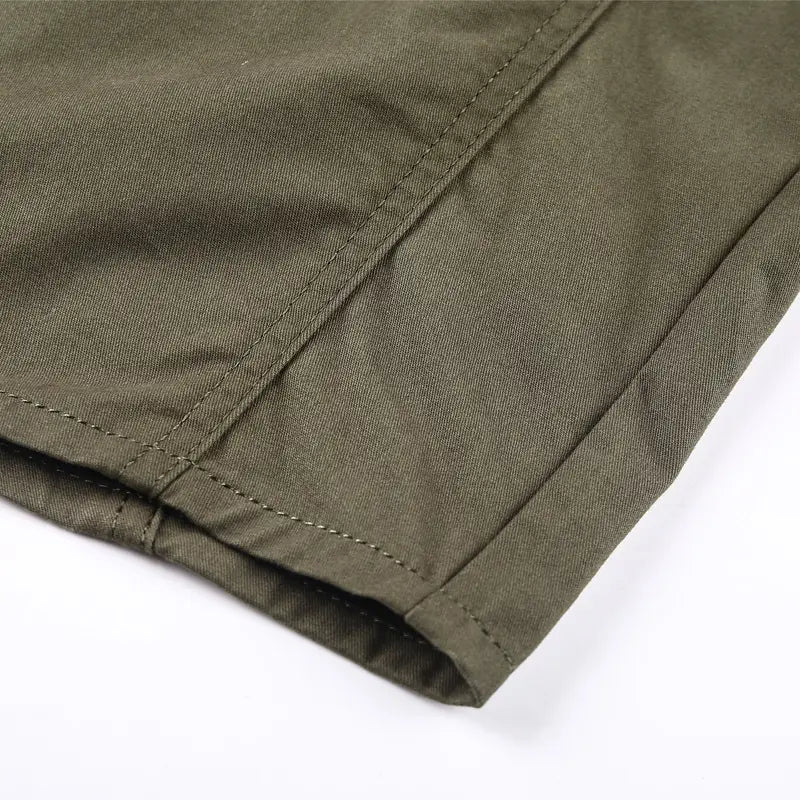 olive green cotton fabric with neat stitching along the seam of a men cotton casual long sleeve military cargo shirt