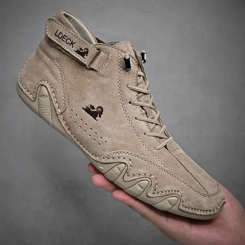 Beige suede men high top leather casual sneaker with a distinctive wavy rubber sole design and black embroidered logo on the side.