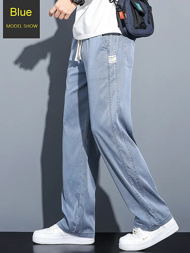 Men’s lyocell casual loose straight drawstring pants in light blue denim with a relaxed fit and subtle stitching details.