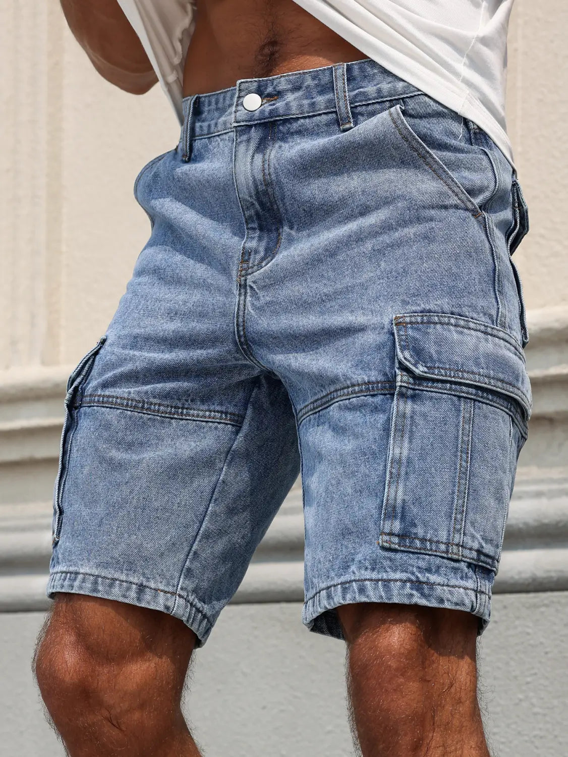 Men blue denim cargo shorts in light-wash with multiple pockets and a casual relaxed regular fit.