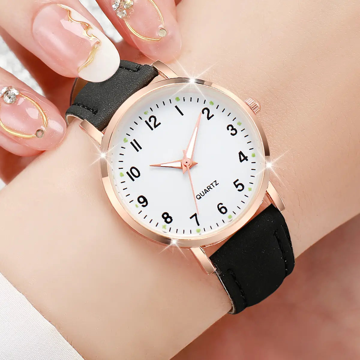 arabic dial rose gold quartz watch for women with a minimalist white face and black leather strap