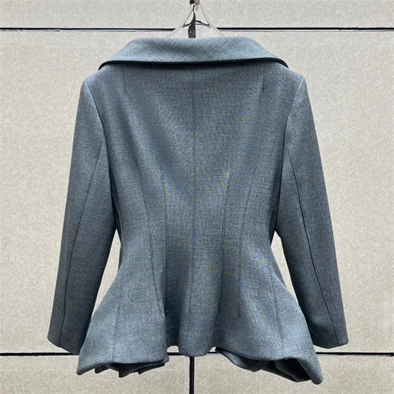 Veste blazer grise, ajustée, en laine, avec col à encoches et bas volanté (peplum), associée à une jupe crayon grise taille haute de longueur genou au style Y2K.