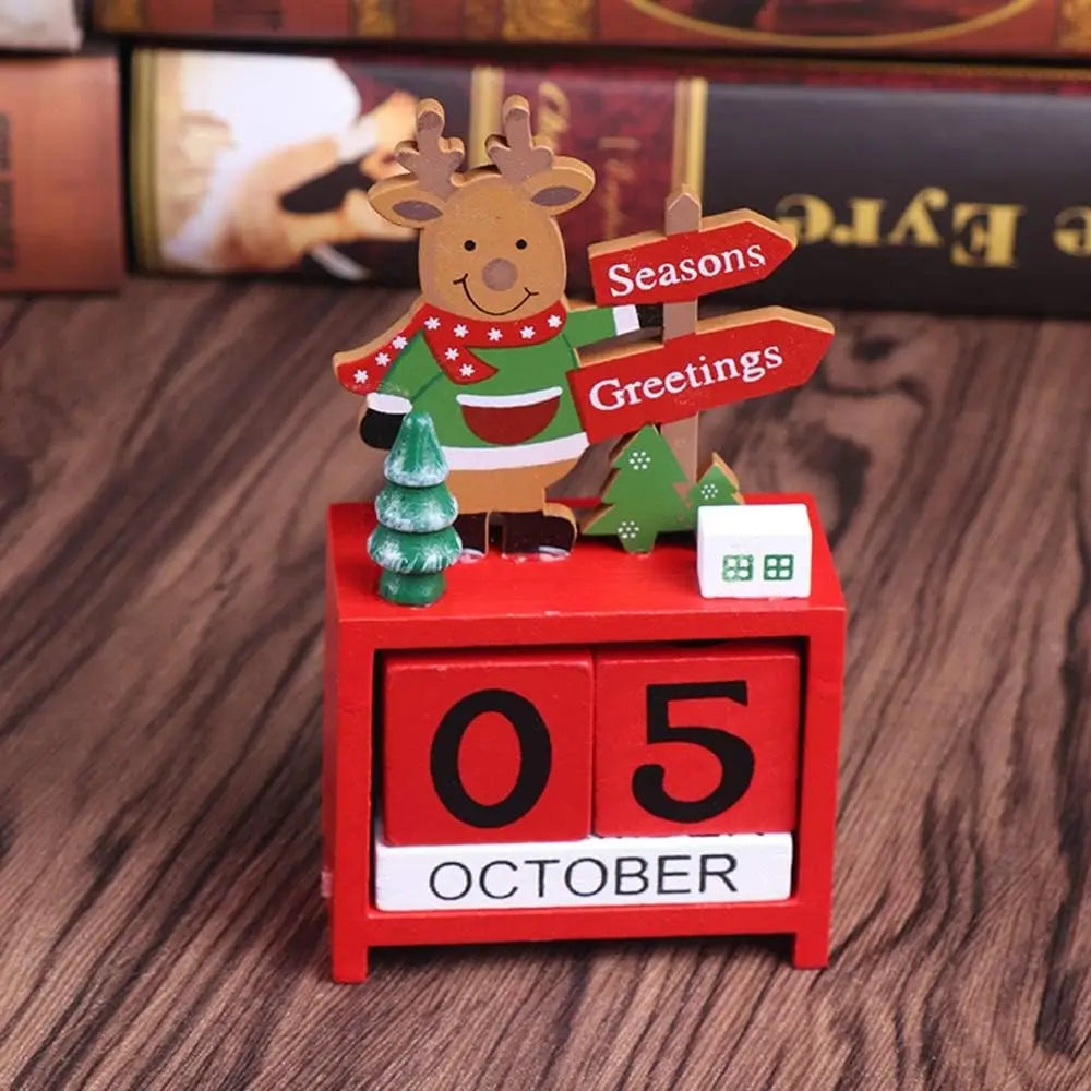 Red wooden Christmas countdown calendar blocks featuring a festive reindeer figurine wearing a green sweater and holding directional signs reading seasons and greetings.