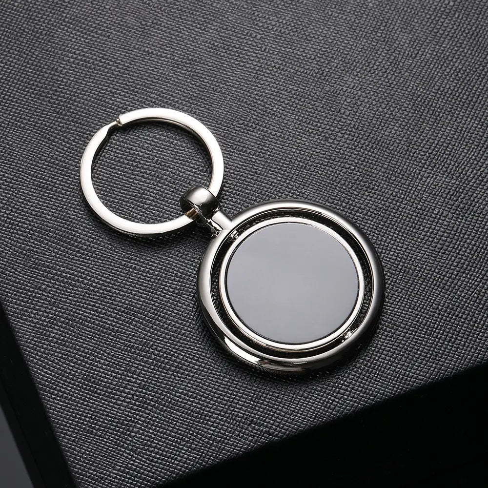 Rotating silver circle keychain gift featuring a silver metallic design with a polished outer ring and matte inner disc.