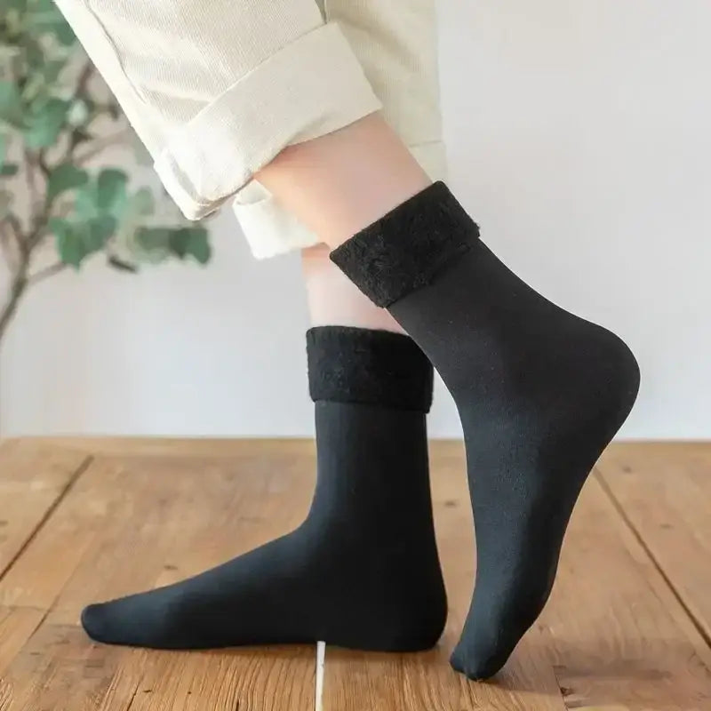 Black winter thermal socks with a plush textured cuff made from cashmere wool for warmth and comfort.