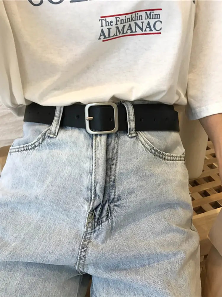 Black leather women belt with a silver-toned rectangular buckle designed as a casual fashion waist strap.