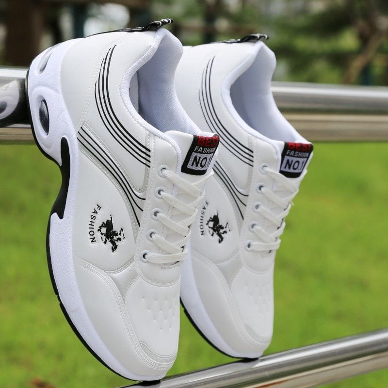 Men orthopedic slip-on walking shoes in white with black stripes and logo, featuring white laces and a bold rubber sole.