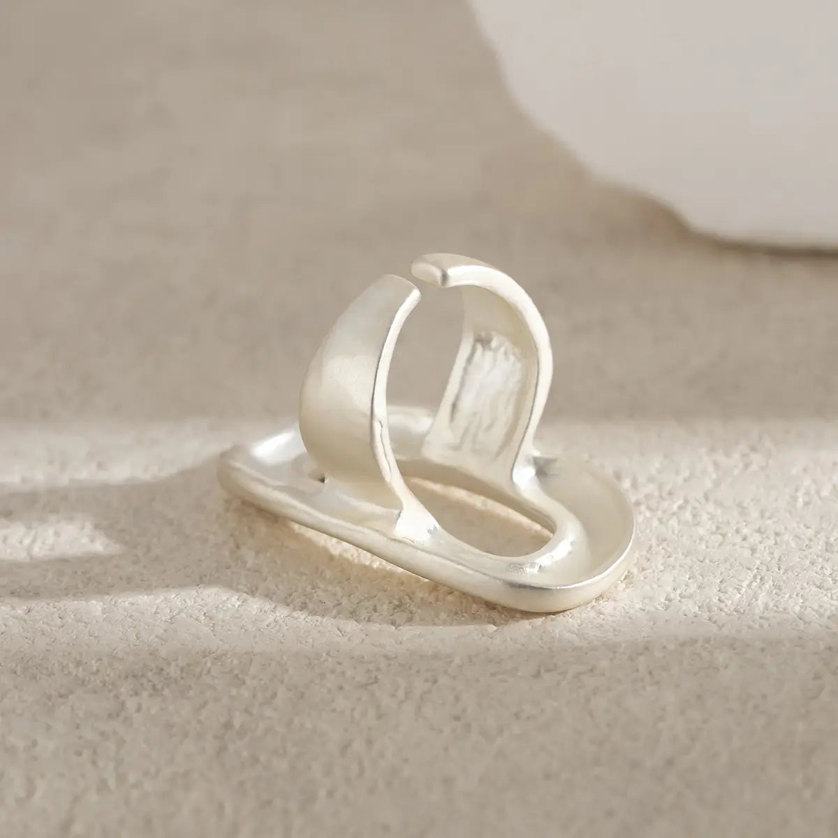 A sleek minimalist silver geometric oval open ring for women with a modern open design featuring smooth curves and a polished finish.