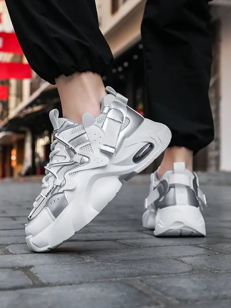 men chunky air cushion casual sneakers in white and silver featuring a thick layered design with mesh panels and reflective accents