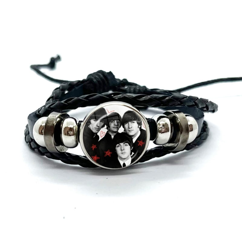Black braided leather bracelet featuring a circular glass dome charm with a black and white image of The Beatles, accented by silver-toned metal beads.
