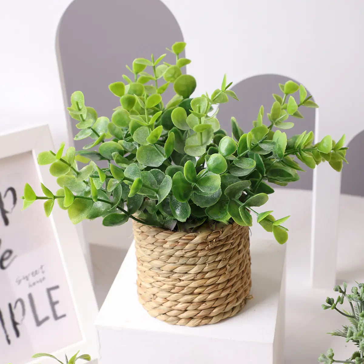 a lush green artificial eucalyptus plant in a small woven natural fiber basket ideal for small potted plants and eucalyptus flowers decor measuring 17cm.