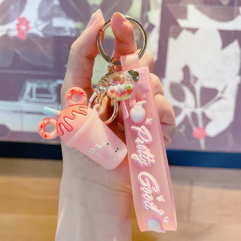 Pink silicone ice cream keychain with a cute drink-shaped pvc charm, donut accents, and a pretty good strap for personalized hanging.