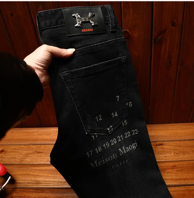 mens slim fit printed black denim jeans back side showing distinctive embroidered logo patch at waistband and numerical markings on back pocket