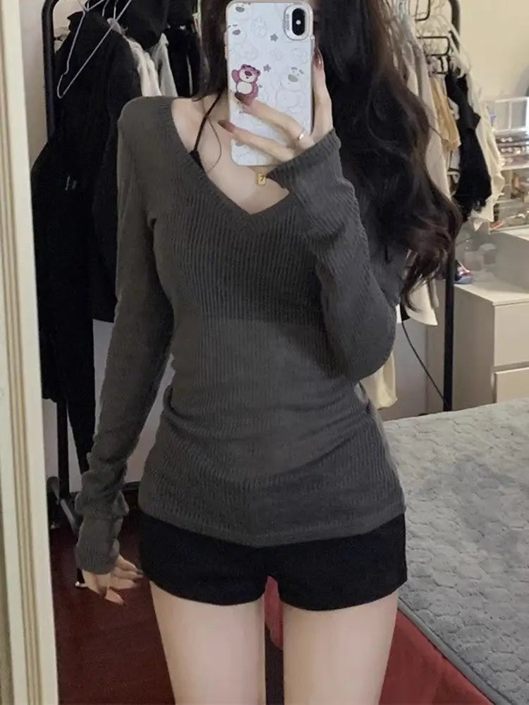 Ein dunkelgrauer gerippter Strick-Longsleeve-Top mit tiefem V-Ausschnitt, entworfen als Slim Casual Tee für Damen.