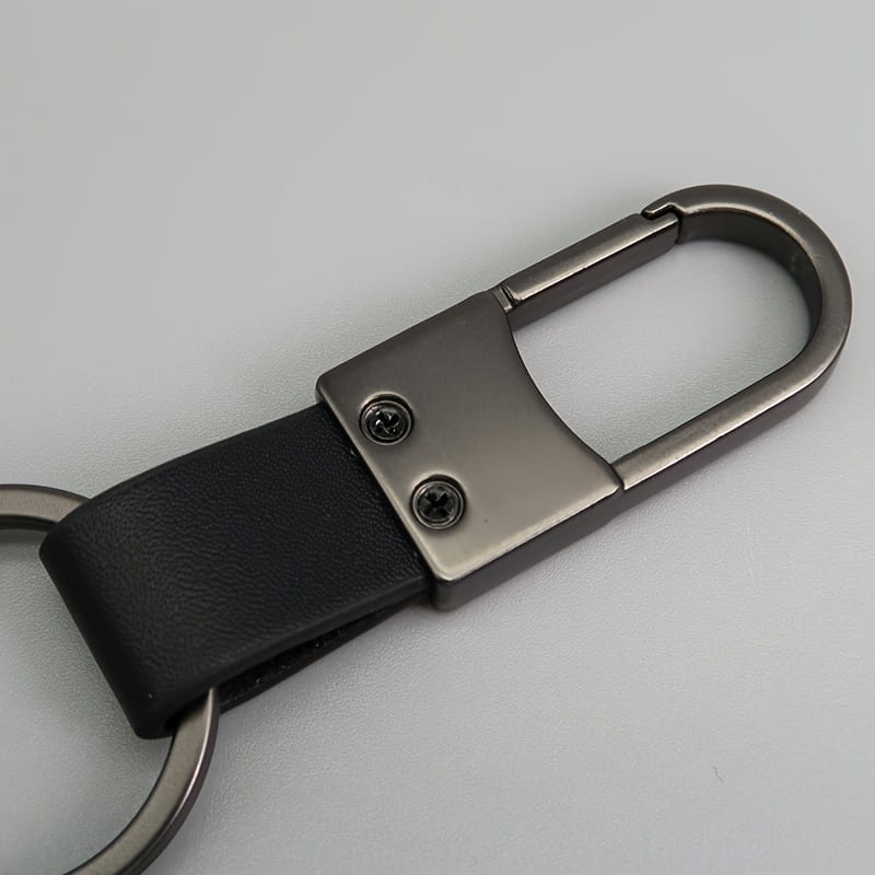 Black leather colorful leather car keychain with minimalist matte silver metal carabiner and two visible screws.