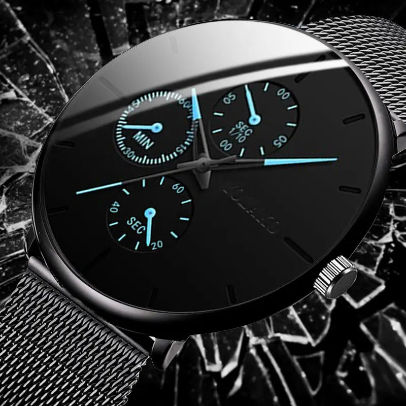 Montre à quartz ultrafine noire à maille pour hommes, avec un cadran chronographe doté d’aiguilles éclairées en bleu et d’un bracelet à maillons en maille.