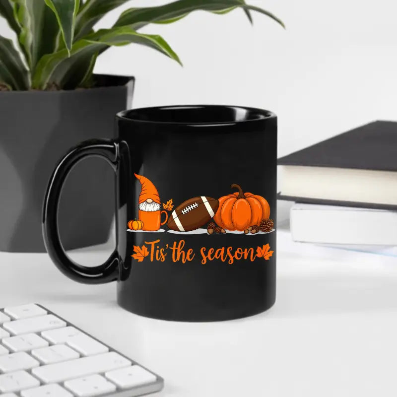 Black ceramic Easter egg coffee mug with a festive orange and brown autumn design featuring a gnome, football, pumpkin, and the phrase tis the season.