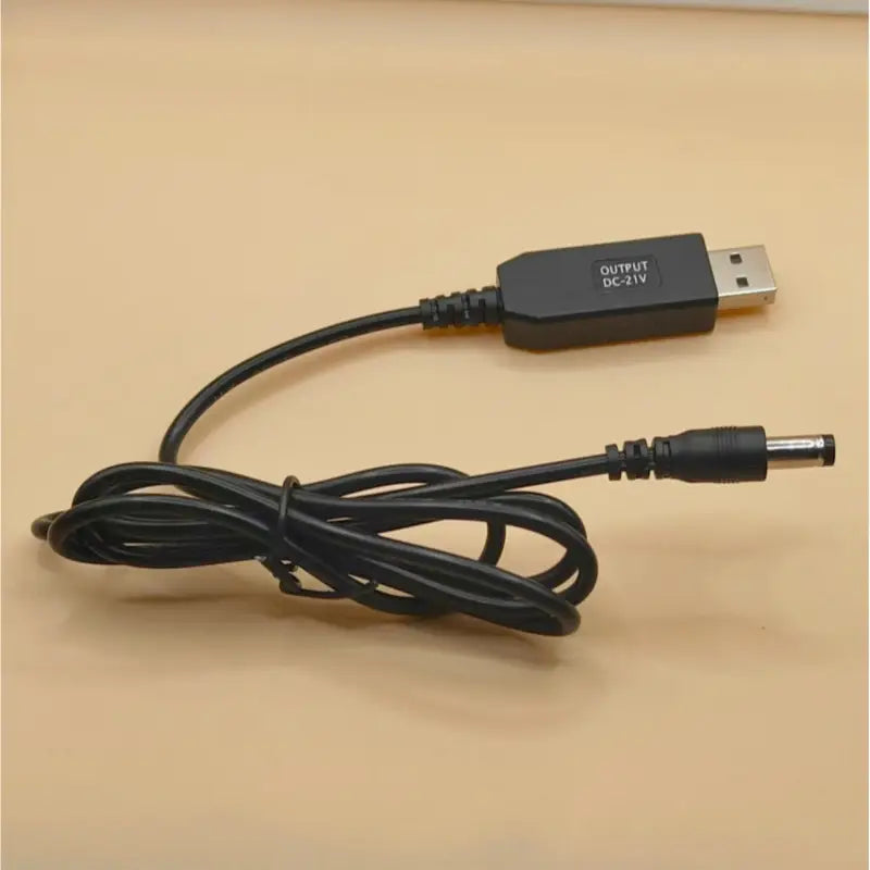 Black usb to dc power adapter cable with a 5.5mm barrel connector and output dc 21v marking for 5v to 21v usb boost charging cable.