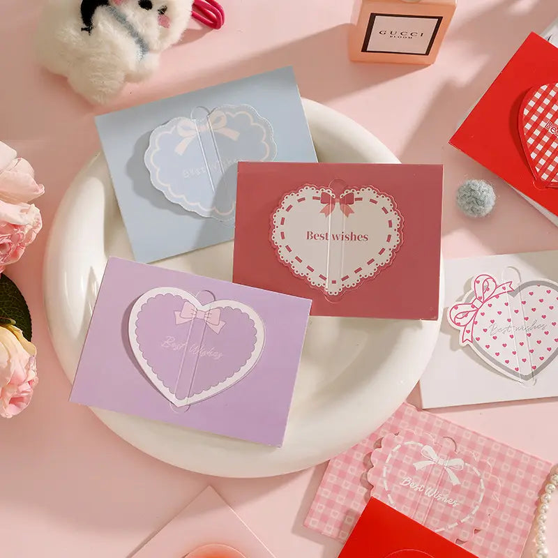 Pastel-colored 3d heart-shaped greeting cards set with lace trim and bow details featuring best wishes text in a delicate script for valentine and wedding notes.