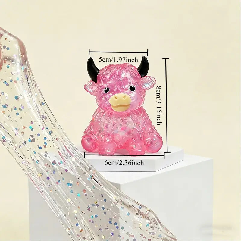 Pink translucent plastic highland cow sensory fidget toy with black horns and a yellow nose designed for stress relief.