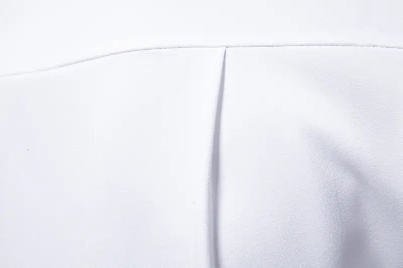 white fabric with a smooth slightly textured surface and a clean precise seam down the center of a men asymmetrical slant collar long sleeve casual shirt