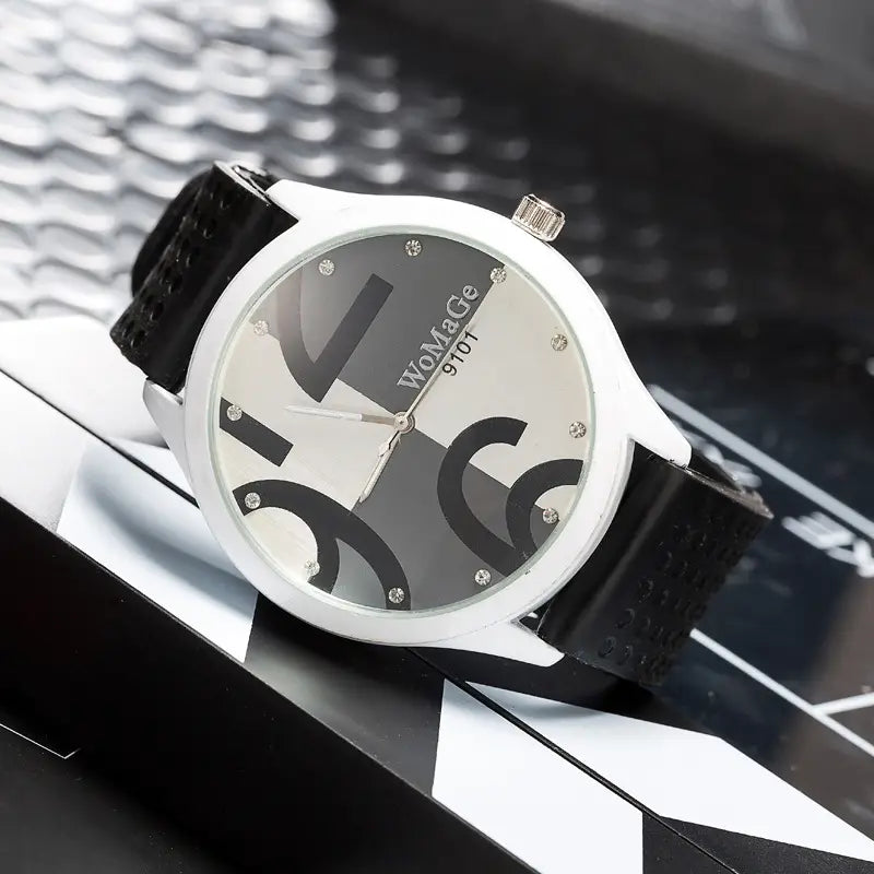 White-faced womage 9701 watch with black and silver abstract design diamond hour markers and black perforated strap in green silicone quartz fashion style.