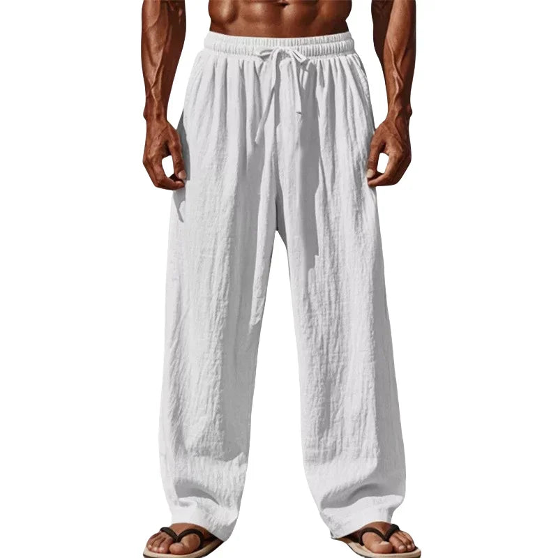 Men cotton linen casual pants in white featuring loose straight legs with an elastic waistband and drawstring for comfort.