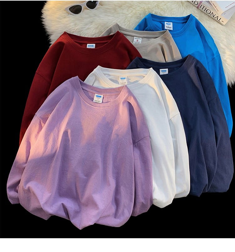 Oversized long sleeve blank t-shirt featuring a soft gradient purple to pink color with a relaxed fit and ribbed crew neckline.
