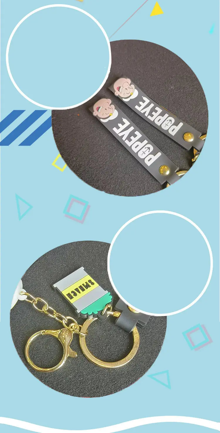 Black rubber popeye silicone keychain with gold-tone metal hardware and white printed letters featuring a cartoon popeye face on one end for bag pendant use.