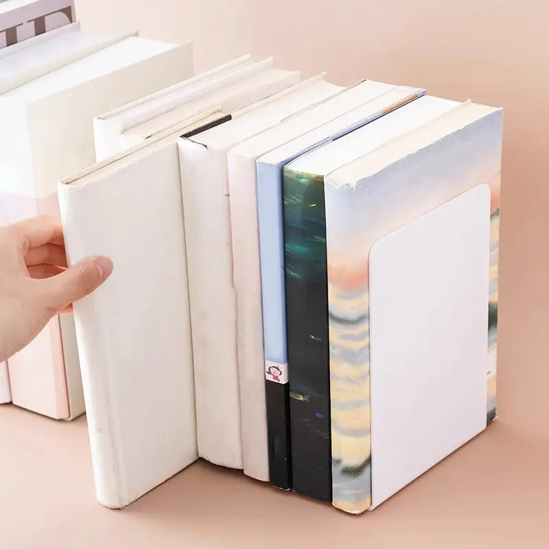 White rectangular metal minimalist l shaped bookend with smooth solid surface holding books upright on desktop
