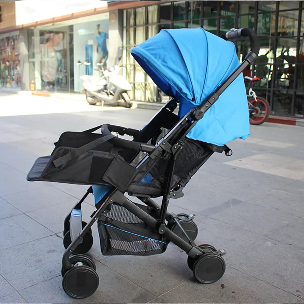 blue and black foldable universal stroller extension footrest with canopy mesh side panels and storage basket shown from the back side