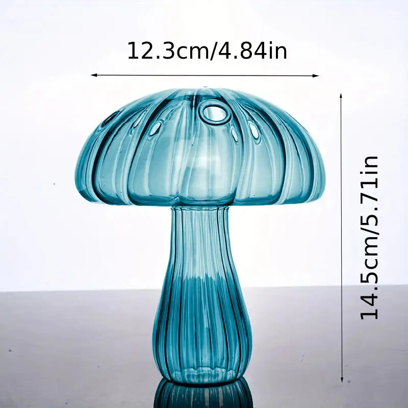A translucent blue glass mushroom bud vase with a ribbed texture and glossy finish designed as a colorful Nordic plant holder.