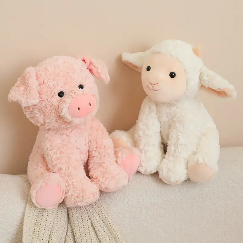 Plush stuffed animal toy 25cm featuring a soft pink plush pig with curly texture and matching bow seated beside a white fluffy lamb stuffed toy.