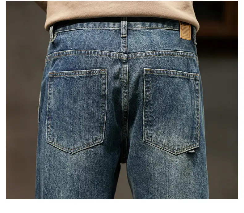 men loose denim harem jeans showing the back side with blue faded wash denim and classic back pockets