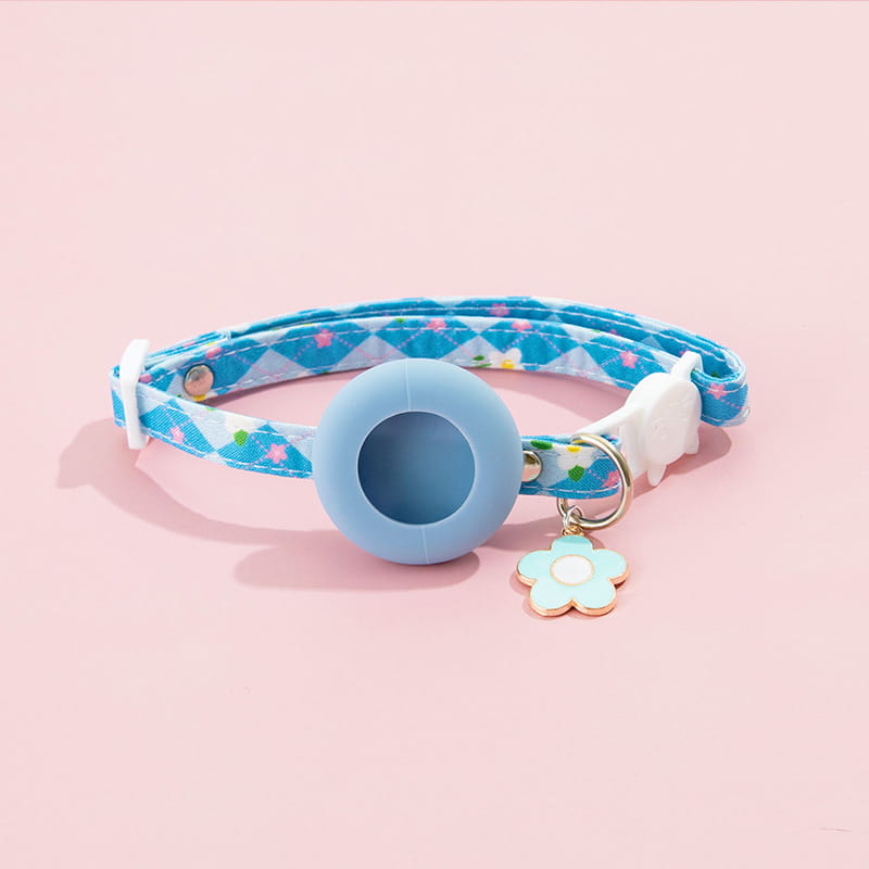 a light blue silicone airtag cat collar with a patterned fabric band and a matching flower-shaped charm featuring an airtag protective case for outdoor park dog and park dog cat use