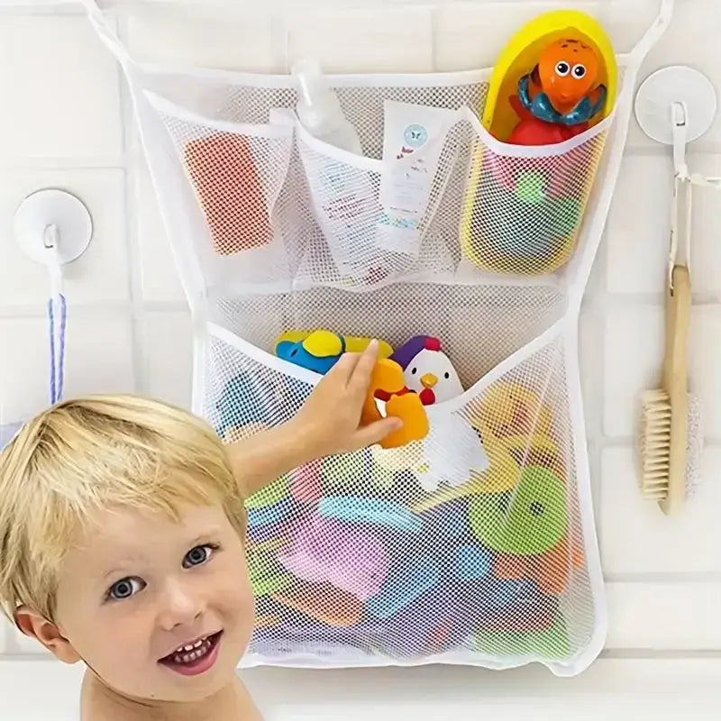 White mesh bath toy storage bag with suction cups featuring multiple compartments holding colorful rubber toys and toiletries.