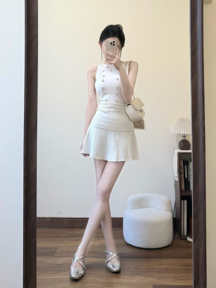 white pleated mini dress with button detailing and closure type featured in a knit tank top and pleated skirt set with length 40cm and size information available