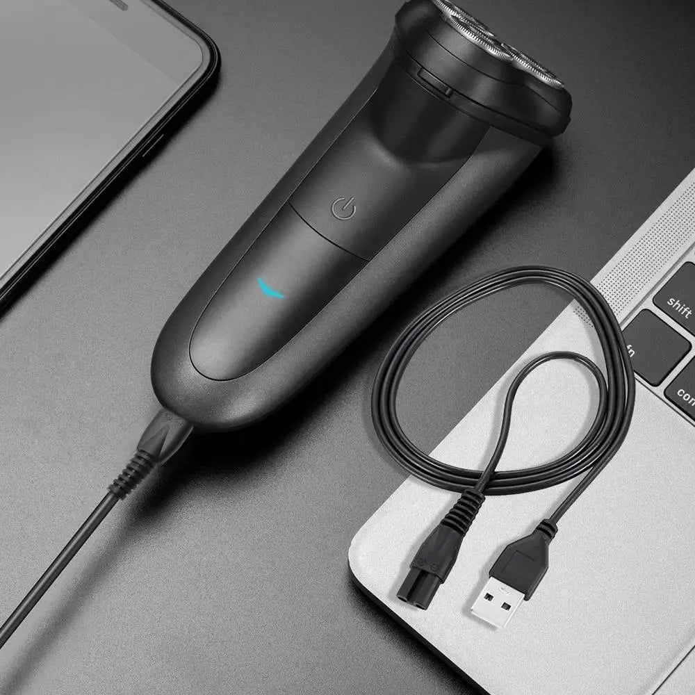 schwarzer Meridian-Elektrorasierer mit schlankem, ergonomischem Design und dreiklingenigem Kopf, dargestellt mit USB-Ladekabel für einen bequemen Austausch.