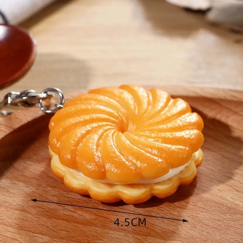 Orange and white layered chocolate biscuit cartoon keychain with a glossy finish and bag pendant design.