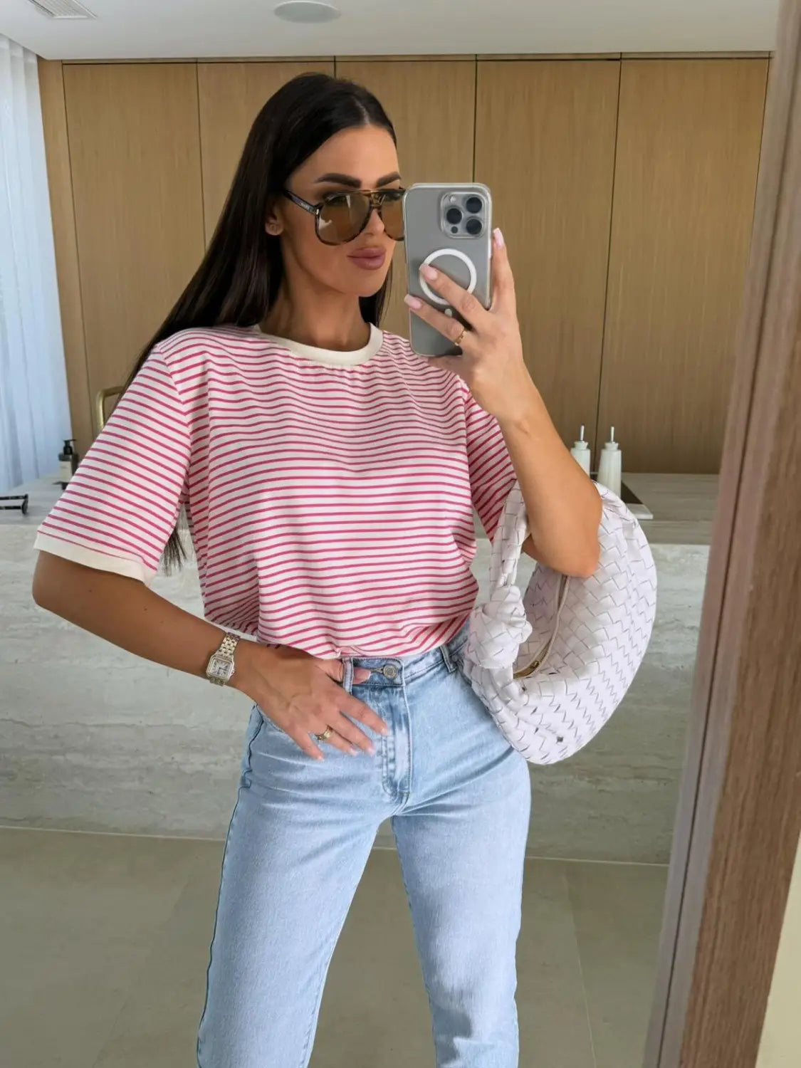 Pink and white striped short sleeve t shirt with a cream-colored ribbed crew neckline casual summer top.