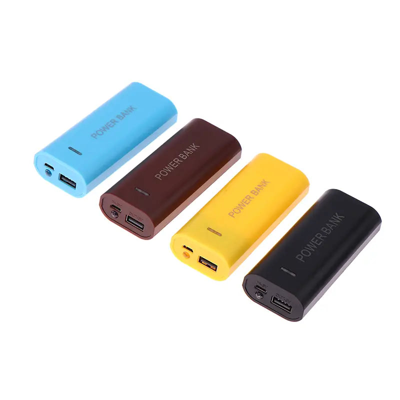 four rectangular portable power banks in blue brown yellow and black with power bank printed on each shown as power bank case for 18650 batteries