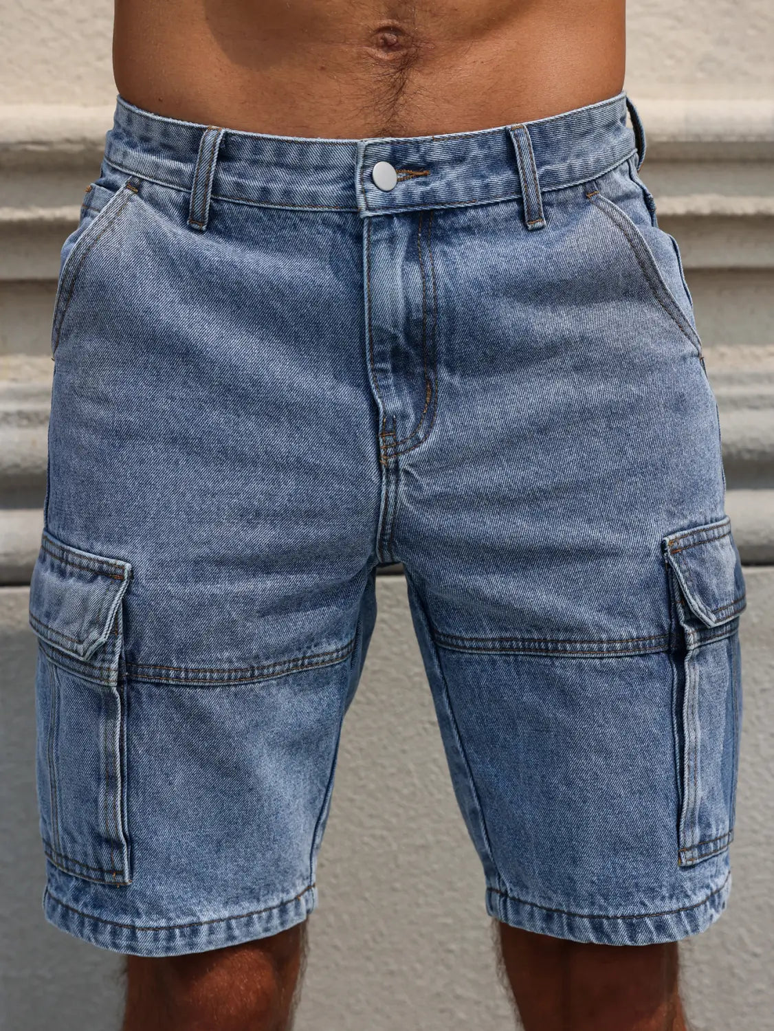 Men blue denim cargo shorts in light wash with regular fit, multiple pockets, and reinforced stitching.