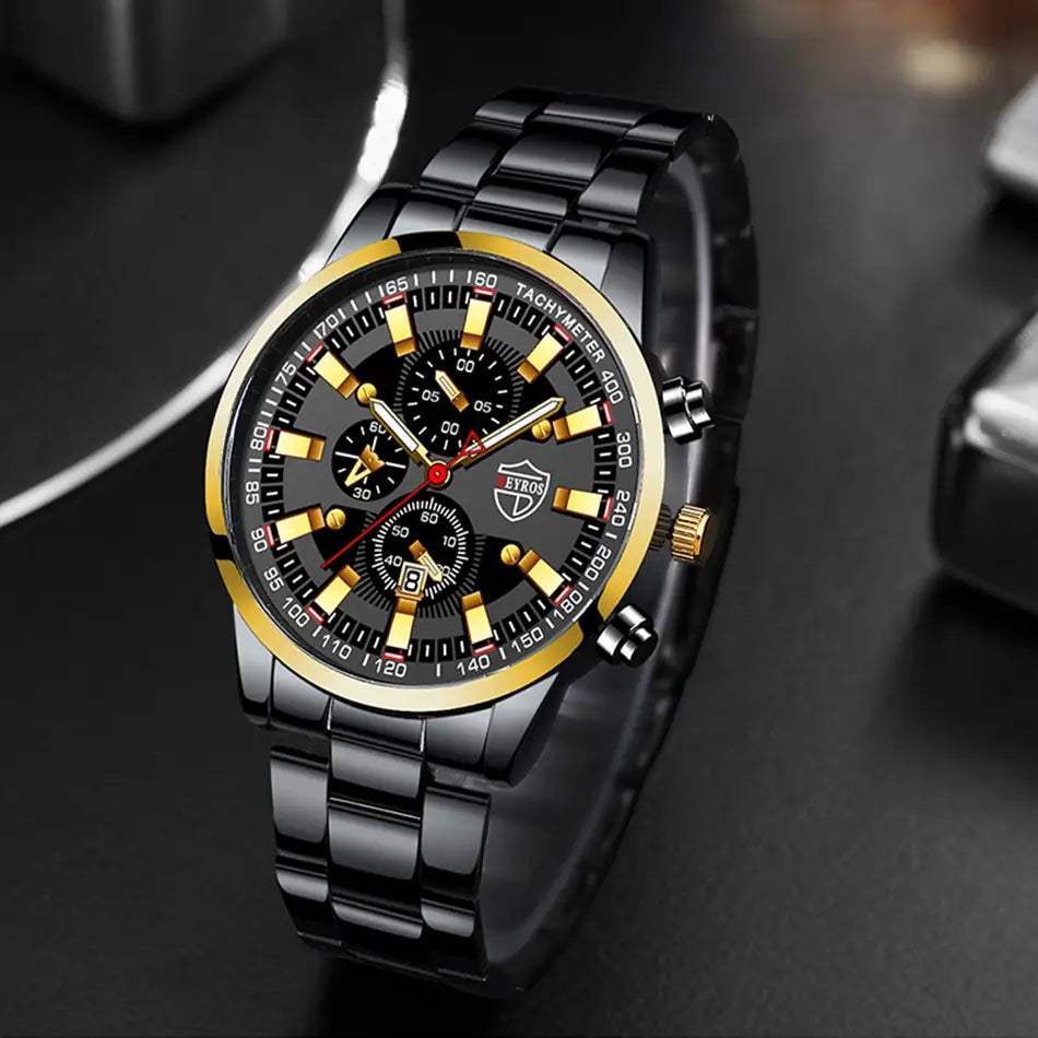 Montre pour homme Deyros en acier inoxydable noir, en quartz, présentant un cadran de chronographe noir et or, avec un bracelet métallique élégant.