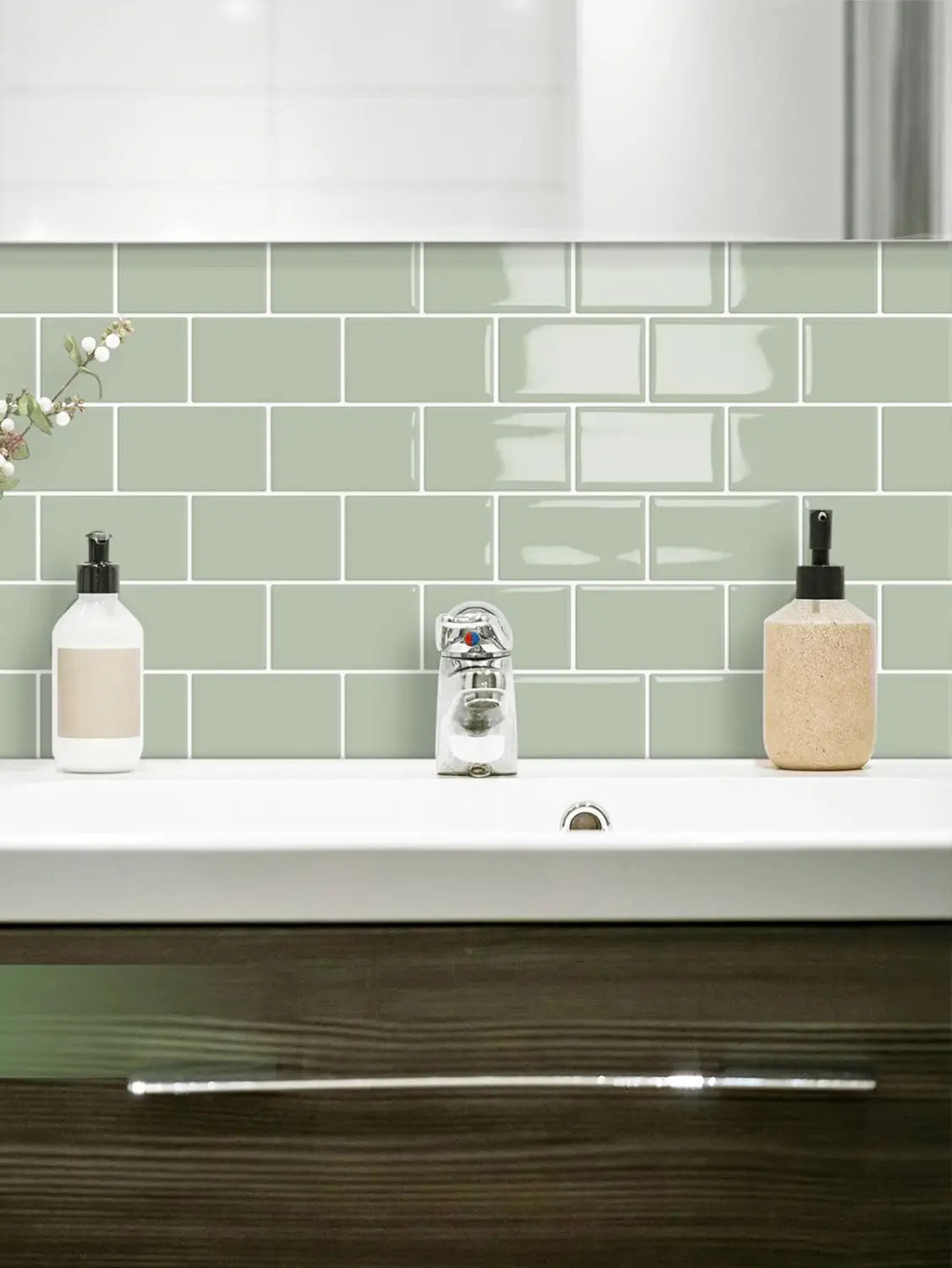 a modern bathroom sink with a sleek minimalist design installed against a glossy white subway peel and stick tile backsplash suitable for direct contact and fresh paint surfaces